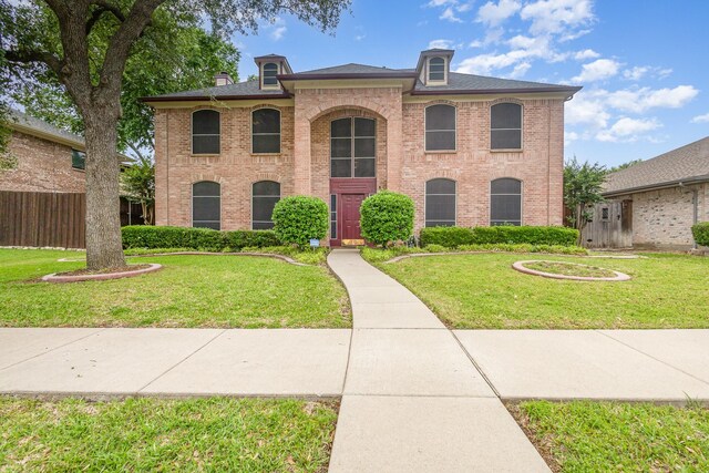5509 Allen Ln, Rowlett, TX 75088 - view of front of home with brick siding, a front lawn, and a chimney