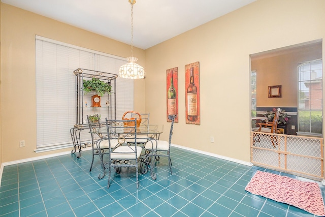 5509 Allen Ln, Rowlett, TX 75088 - dining area with dark tile patterned flooring, a chandelier, and baseboards