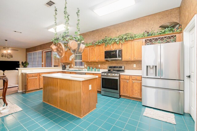 5509 Allen Ln, Rowlett, TX 75088 - kitchen featuring appliances with stainless steel finishes, light countertops, tile patterned floors, and a sink