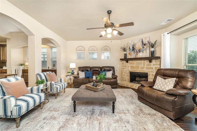 1519 Eminence Ln, Saint Paul, TX 75098 - living area with a ceiling fan, wood finished floors, arched walkways, and a fireplace