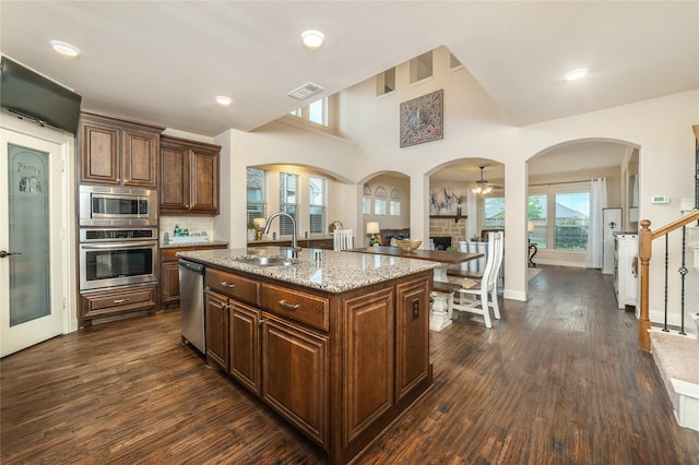 1519 Eminence Ln, Saint Paul, TX 75098 - kitchen with stainless steel appliances, a sink, dark wood-style floors, light stone counters, and plenty of natural light