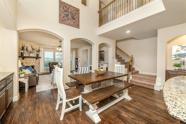 1519 Eminence Ln, Saint Paul, TX 75098 - dining space with dark wood finished floors, stairs, ceiling fan, a towering ceiling, and baseboards