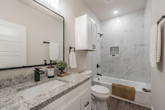bathroom featuring toilet, shower / bathtub combination, vanity, recessed lighting, and wood finished floors