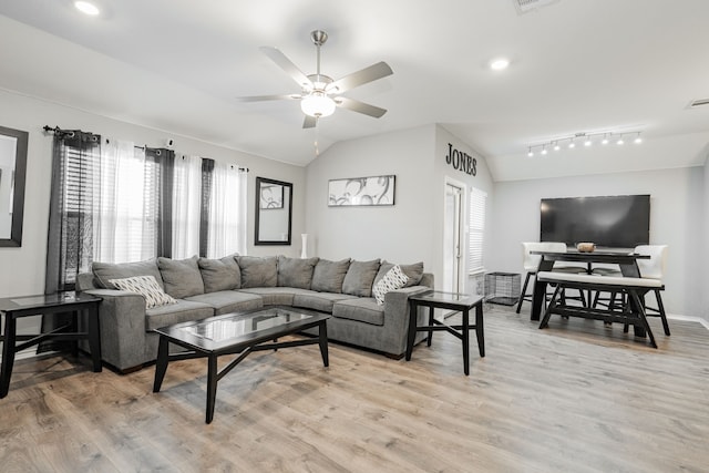 living room featuring healthy amount of natural light, lofted ceiling, light wood-style flooring, ceiling fan, and recessed lighting