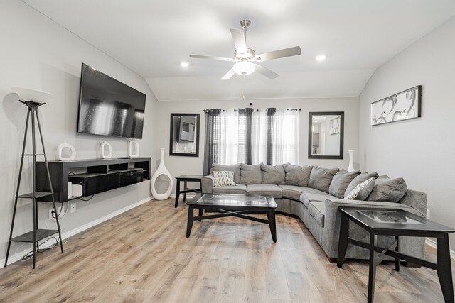 living room featuring lofted ceiling, ceiling fan, light wood-style flooring, baseboards, and recessed lighting