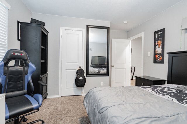 bedroom featuring carpet and baseboards