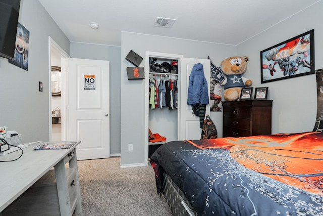 carpeted bedroom featuring a closet and baseboards
