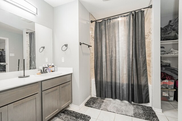 full bathroom featuring tile patterned floors, vanity, and shower / bathtub combination with curtain