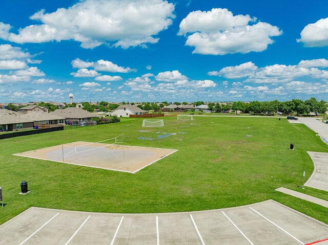view of community with an area for soccer, uncovered parking, and a residential view