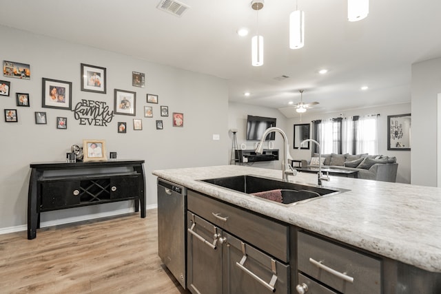 kitchen featuring a sink, dishwasher, light wood-style floors, dark brown cabinetry, and recessed lighting