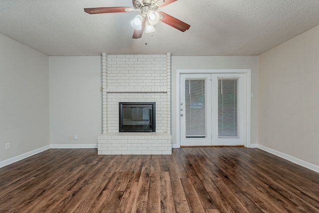 1600 Lagoona Ln, Edgecliff Village, TX 76134 - unfurnished living room with ceiling fan, wood finished floors, a textured ceiling, a brick fireplace, and baseboards