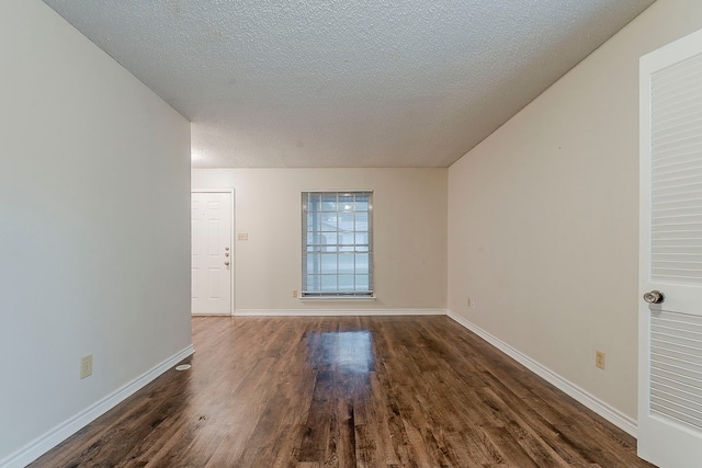 1600 Lagoona Ln, Edgecliff Village, TX 76134 - spare room with dark wood finished floors, baseboards, and a textured ceiling