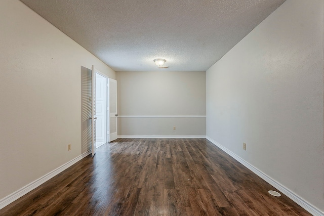1600 Lagoona Ln, Edgecliff Village, TX 76134 - empty room with dark wood-type flooring, a textured ceiling, and baseboards