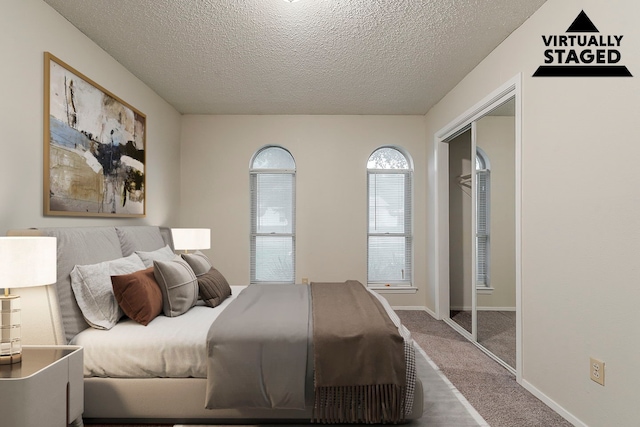 1600 Lagoona Ln, Edgecliff Village, TX 76134 - bedroom with carpet floors, a textured ceiling, a closet, and baseboards