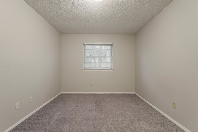 1600 Lagoona Ln, Edgecliff Village, TX 76134 - empty room with carpet floors, a textured ceiling, and baseboards