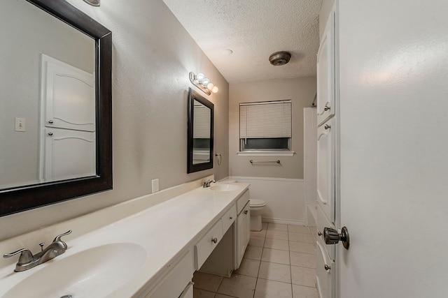 1600 Lagoona Ln, Edgecliff Village, TX 76134 - full bathroom featuring tile patterned floors, toilet, a textured ceiling, double vanity, and baseboards
