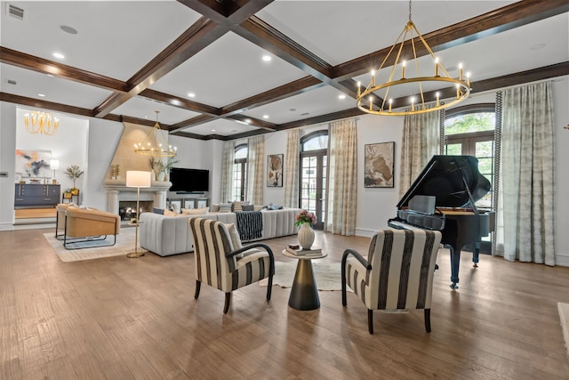 living room featuring a chandelier, wood finished floors, coffered ceiling, beamed ceiling, and baseboards