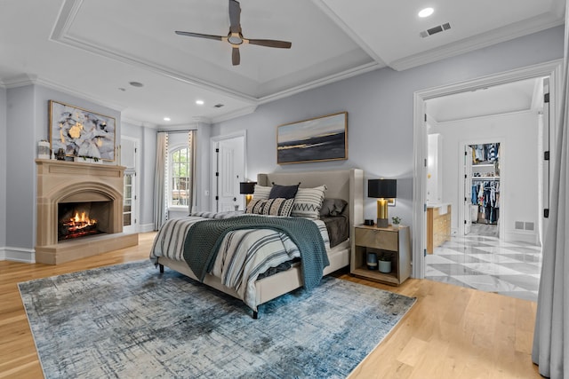 1100 La Paloma Ct, Southlake, TX 76092 - bedroom featuring wood finished floors, a lit fireplace, ornamental molding, recessed lighting, and ceiling fan