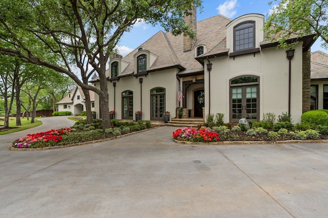 1100 La Paloma Ct, Southlake, TX 76092 - french country home with french doors, stucco siding, a high end roof, and a chimney