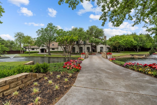 view of home's community featuring a yard and a water view