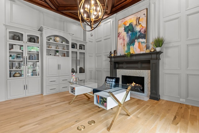 1100 La Paloma Ct, Southlake, TX 76092 - home office featuring a decorative wall, a chandelier, light wood-style floors, a lit fireplace, and coffered ceiling