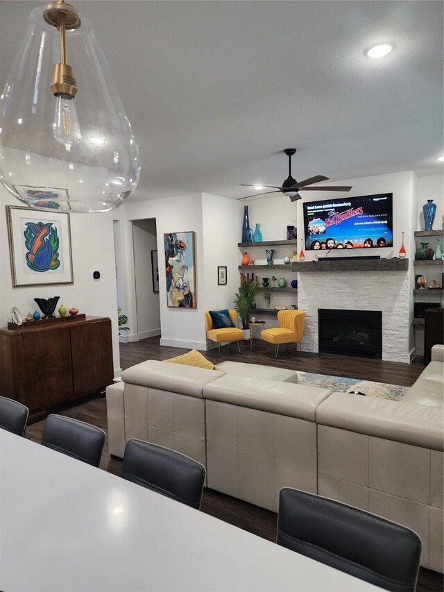 living room with a fireplace, a ceiling fan, wood finished floors, recessed lighting, and baseboards