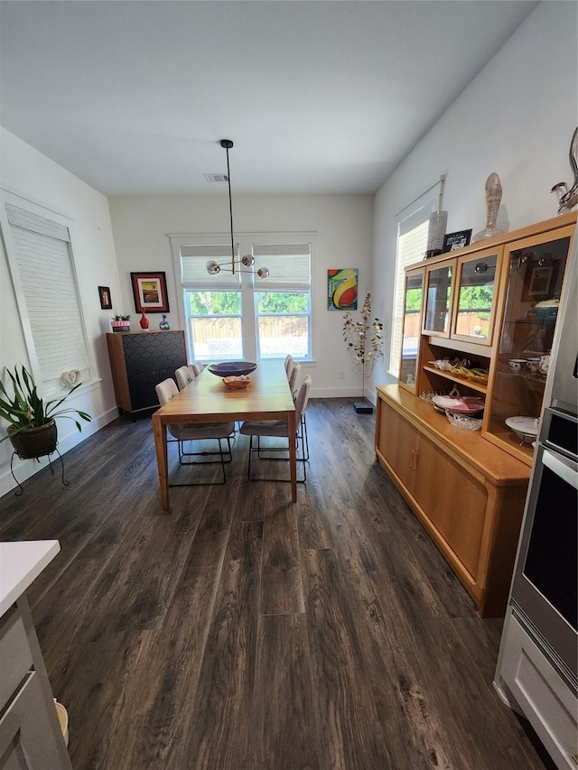 dining room with dark wood-style floors and baseboards