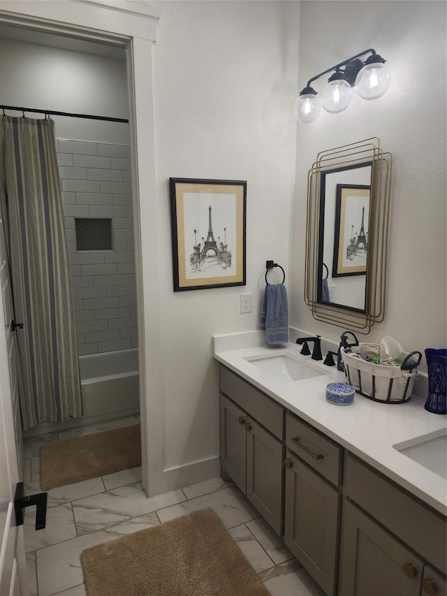 bathroom featuring baseboards, marble finish flooring, double vanity, and shower / bathtub combination with curtain