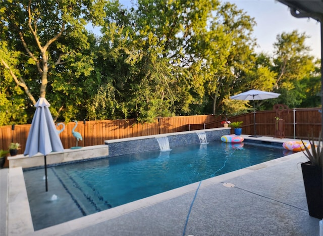 view of swimming pool featuring a fenced backyard