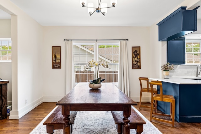 5533 Bonita Ave, Dallas, TX 75206 - dining space featuring a chandelier, baseboards, and dark wood-style flooring