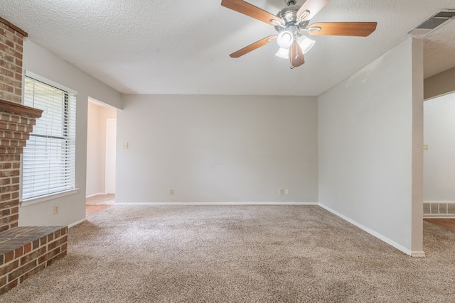spare room featuring carpet, a ceiling fan, baseboards, and a textured ceiling