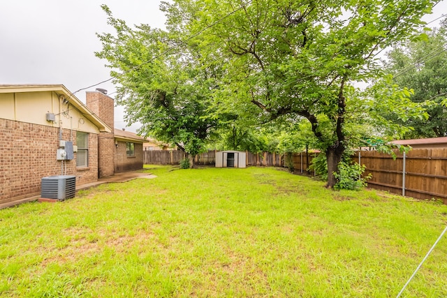 view of yard featuring a storage shed, an outbuilding, and central AC unit