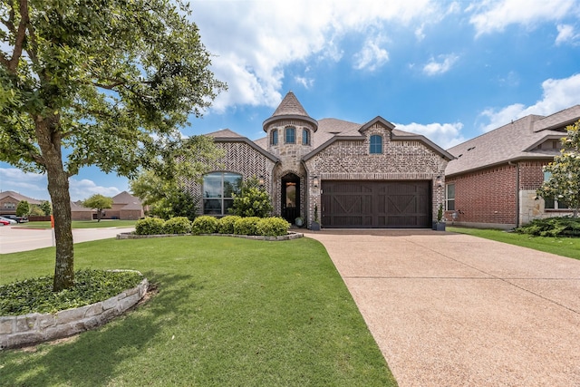 french country style house with brick siding, concrete driveway, an attached garage, and a front lawn