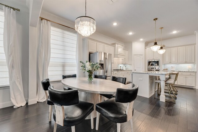 dining room featuring dark wood finished floors, crown molding, a chandelier, and recessed lighting