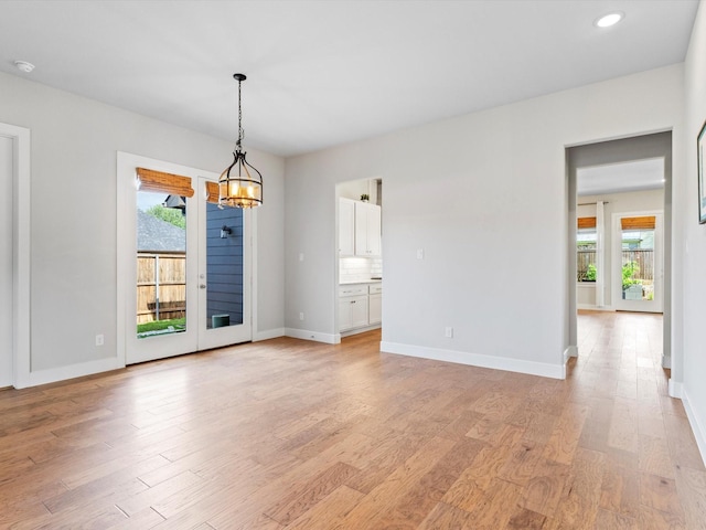 323 Green Meadow Dr, Little Elm, TX 75068 - unfurnished room featuring light wood-style floors, baseboards, recessed lighting, a chandelier, and a smoke detector
