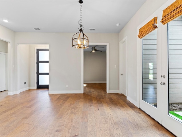323 Green Meadow Dr, Little Elm, TX 75068 - unfurnished dining area with plenty of natural light, light wood-style flooring, a chandelier, and a ceiling fan