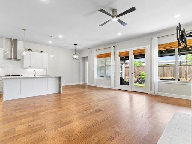 323 Green Meadow Dr, Little Elm, TX 75068 - unfurnished living room featuring a ceiling fan, light wood finished floors, baseboards, recessed lighting, and a sink