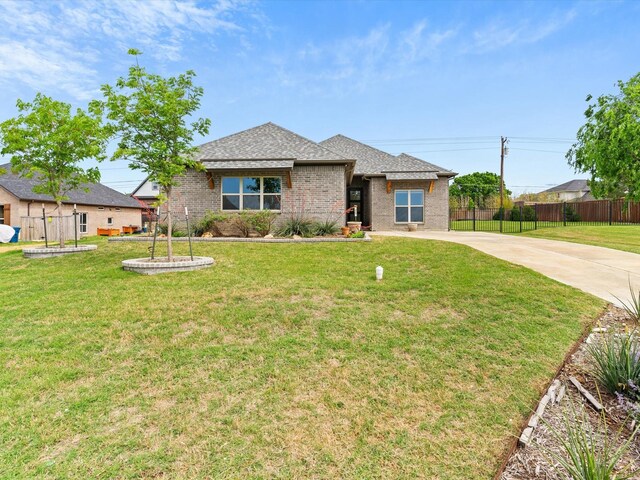 323 Green Meadow Dr, Little Elm, TX 75068 - view of front of house with driveway, brick siding, and roof with shingles