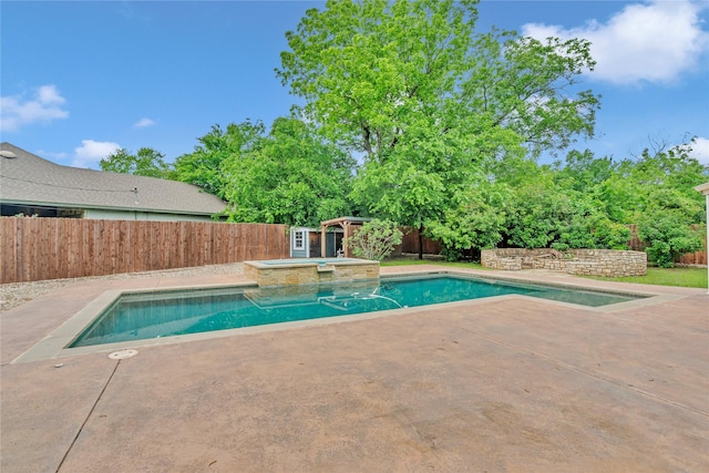 view of pool with a patio area, a fenced backyard, and a pool with connected hot tub
