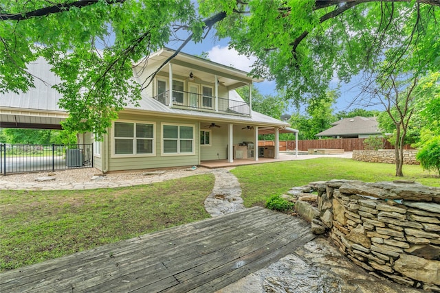 back of property with ceiling fan, central AC, a wooden deck, and a patio area