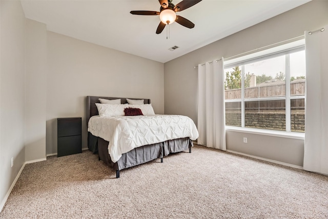 carpeted bedroom with baseboards and a ceiling fan