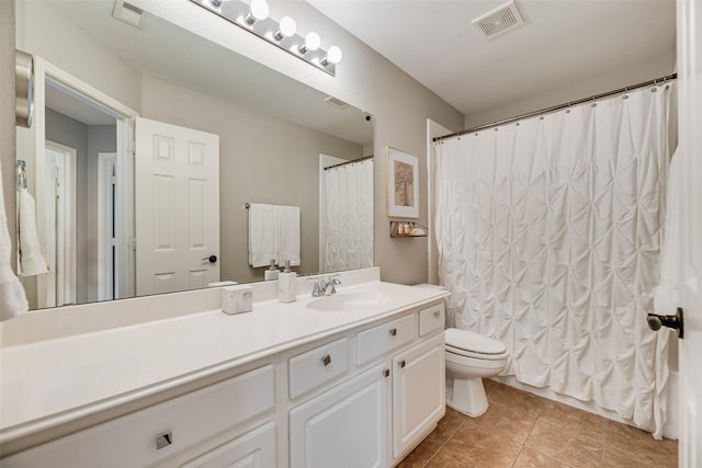 bathroom featuring toilet, tile patterned flooring, and vanity