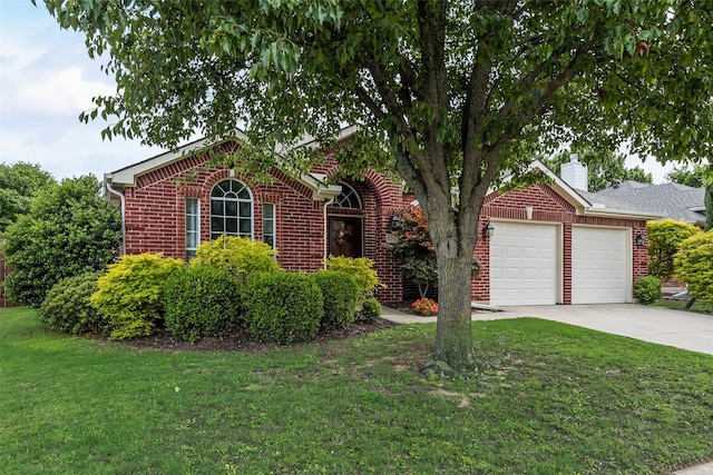 view of front of home featuring a garage, brick siding, a front lawn, driveway, and a chimney