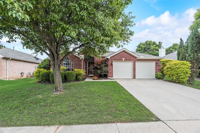 view of front of property featuring brick siding, an attached garage, a front yard, driveway, and a chimney