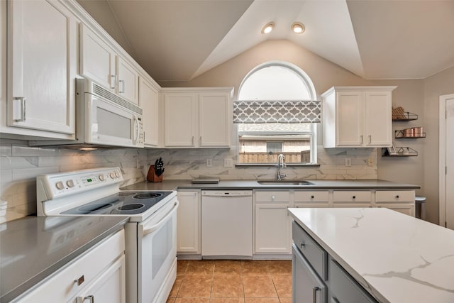 kitchen with white appliances, a sink, vaulted ceiling, white cabinetry, and open shelves