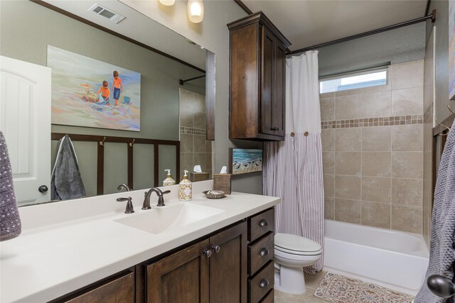 bathroom featuring toilet, vanity, shower / bath combo with shower curtain, and tile patterned floors