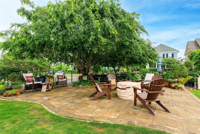view of patio featuring fence and a fire pit