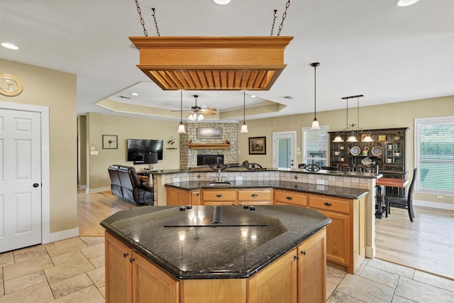 3568 Green Meadows Dr, Glen Rose, TX 76043 - kitchen with a large island, open floor plan, a large fireplace, a raised ceiling, and recessed lighting