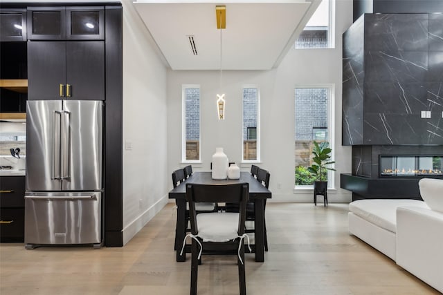 dining room with light wood-style flooring and baseboards