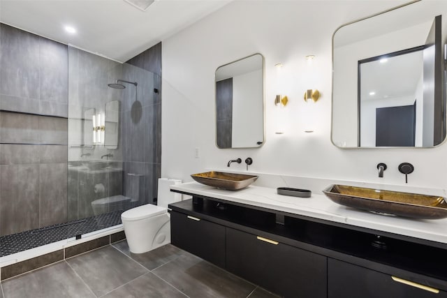 bathroom with toilet, a walk in shower, tile patterned flooring, and double vanity